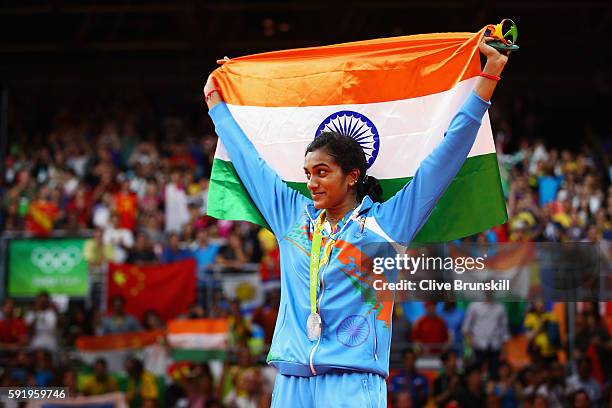Silver medalist V. Sindhu Pusarla of India celebrates during the medal ceremony after the Women's Singles Badminton competition on Day 14 of the Rio...