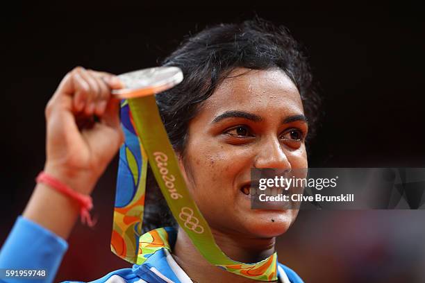 Silver medalist V. Sindhu Pusarla of India celebrates during the medal ceremony after the Women's Singles Badminton competition on Day 14 of the Rio...