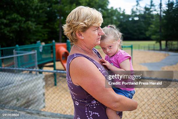 Jill Flagg holds Hannah Allen at Songo Locks School on the second to last day of their special "Jump Start" program. The program has three teachers...