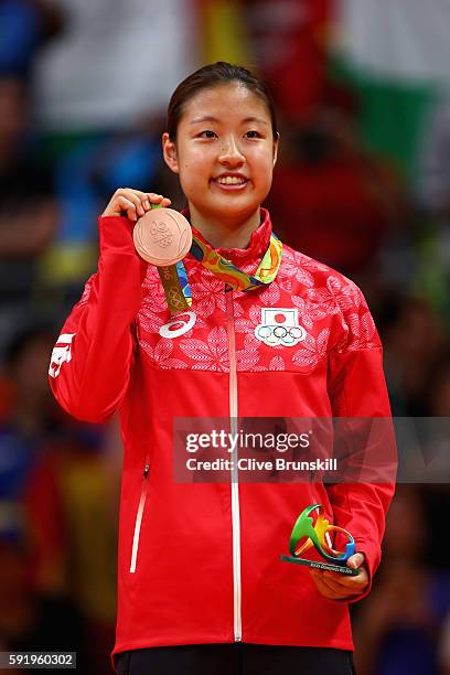 Bronze medalist Nozomi Okuhara of Japan celebrates during the medal ceremony after the Women's Singles Badminton competition on Day 14 of the Rio...