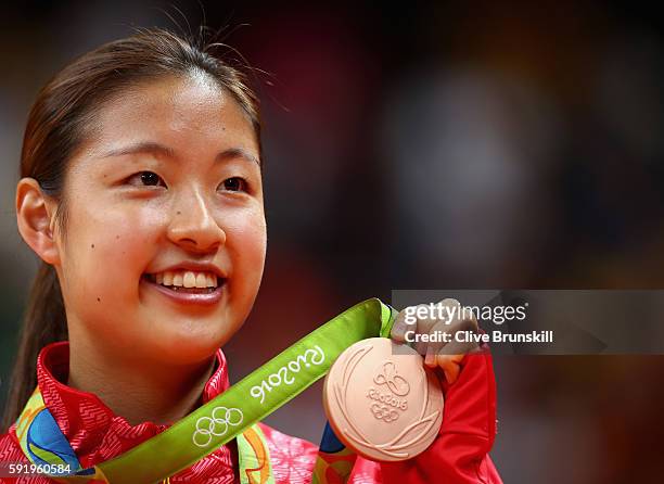 Bronze medalist Nozomi Okuhara of Japan celebrates during the medal ceremony after the Women's Singles Badminton competition on Day 14 of the Rio...