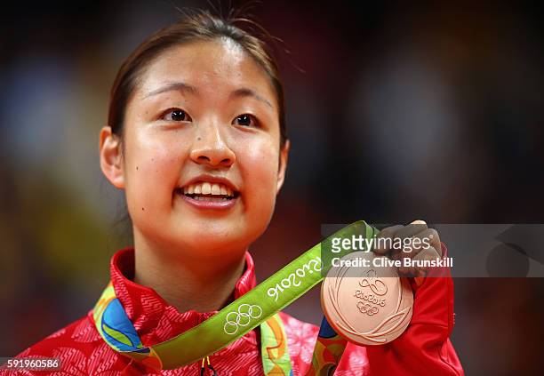 Bronze medalist Nozomi Okuhara of Japan celebrates during the medal ceremony after the Women's Singles Badminton competition on Day 14 of the Rio...