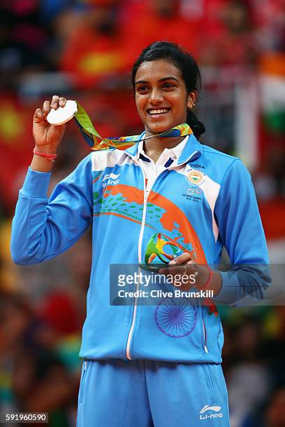 Silver medalist V. Sindhu Pusarla of India celebrates during the medal ceremony after the Women's Singles Badminton competition on Day 14 of the Rio...