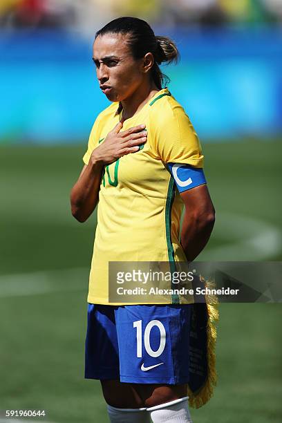 Marta of Brazil lines up for the national anthems before the Women's Olympic Football Bronze Medal match between Brazil and Canada at Arena...
