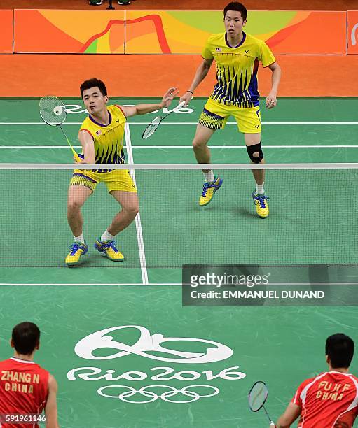 Malaysia's V Shem Goh and Malaysia's Wee Kiong Tan return against China's Zhang Nan and China's Fu Haifeng during their men's doubles Gold Medal...