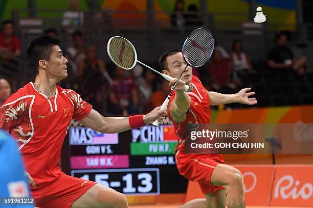 China's Zhang Nan and China's Fu Haifeng return against Malaysia's V Shem Goh and Malaysia's Wee Kiong Tan during their men's doubles Gold Medal...