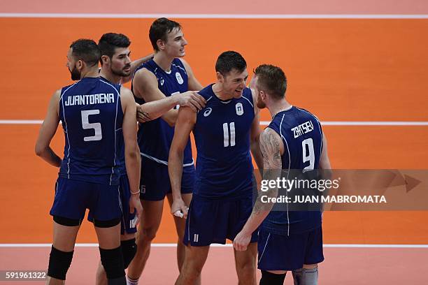 Italy's Ivan Zaytsev celebrates with teammates after serving an ace during the men's semi-final volleyball match between Italy and USA at...