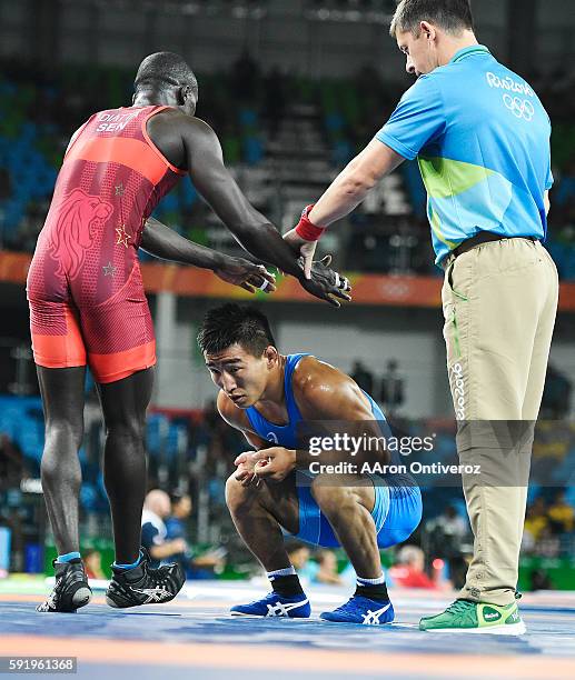 Bekhbayar Erdenebat of Mongolia reacts to losing to Adama Diatta of Senegal during men's 57kg freestyle wrestling on Thursday, August 19, 2016.