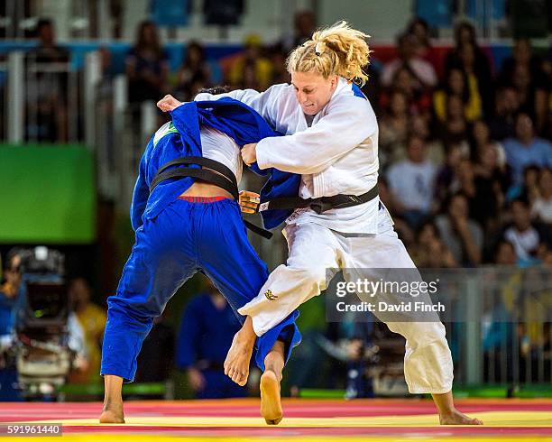 Defending Olympic champion, Kayla Harrison of the United States attacks former world champion, Audrey Tcheumeo of France in their u78kg final....