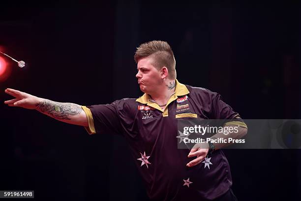New Australian star 21-year-old Corey Cadby plays a shot in his match against sixteen times World Darts Champion Phil Taylor during the first round...