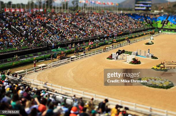 This image was created using a variable plane lens.] Henrik von Eckermann of Sweden riding Yajamila competes during the Equestrian Jumping Individual...