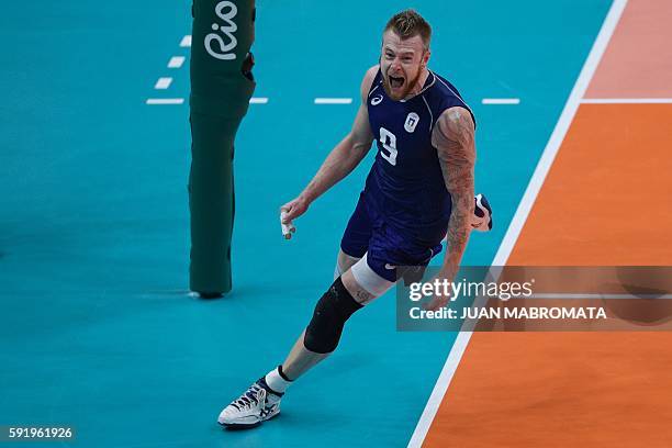 Italy's Ivan Zaytsev celebrates after scoring during the men's semi-final volleyball match between Italy and USA at Maracanazinho Stadium in Rio de...