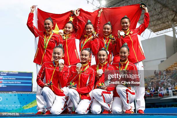 Team China celebrates winning silver on the podium during the medal ceremony for the Synchronised Swimming Teams Free Routine on Day 14 of the Rio...