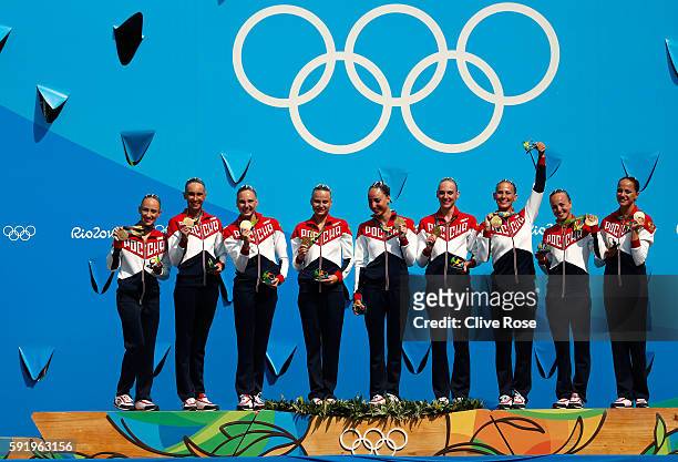 Team Russia celebrates winning gold on the podium during the medal ceremony for the Synchronised Swimming Teams Free Routine on Day 14 of the Rio...