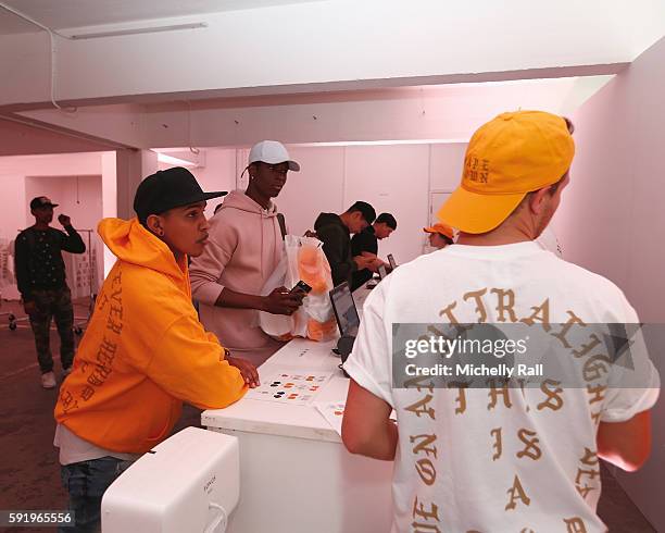 Shoppers check out the latest merchandise from Kanye West at the Kanye West temporary PABLO Store in 107 Bree Street on August 19, 2016 in Cape Town,...