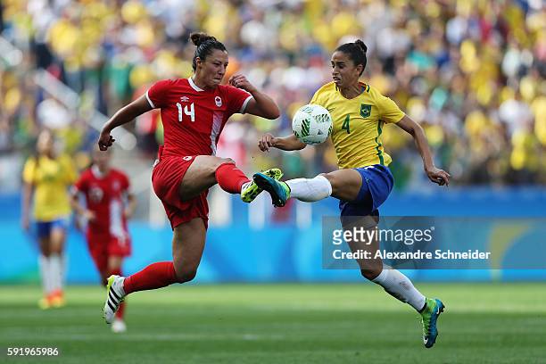 Melissa Tancredi of Canada and Rafaelle of Brazil challenge for the ball during the Women's Olympic Football Bronze Medal match between Brazil and...