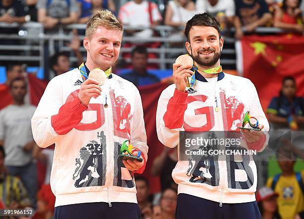 Bronze medalists Great Britain's Marcus Ellis and Great Britain's Chris Langridge stand with their medals on the podium following the men's doubles...