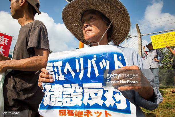 Anti U.S base protester holding a placard to protest against the construction of helipads in front of the main gate of U.S. Military's Northern...