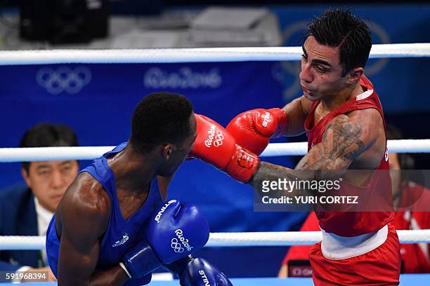 Germany's Artem Harutyunyan fights Azerbaijan's Lorenzo Sotomayor Collazo during the Men's Light Welter Semifinal 2 at the Rio 2016 Olympic Games at...