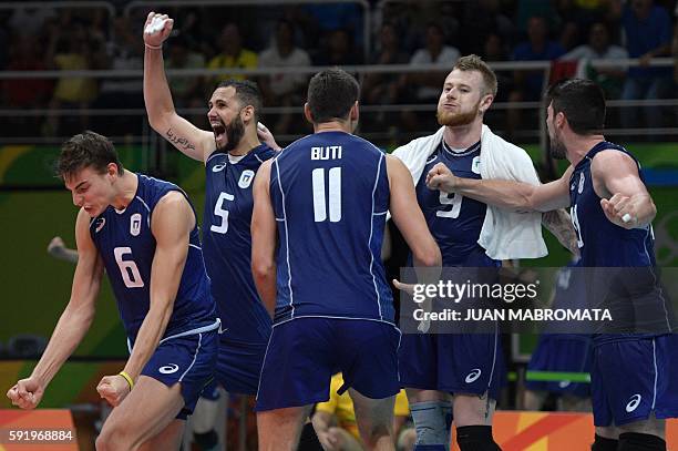 Italy's Simone Giannelli, Italy's Osmany Juantorena and Italy's Ivan Zaytsev celebrate scoring a point after a call was challenged during the men's...