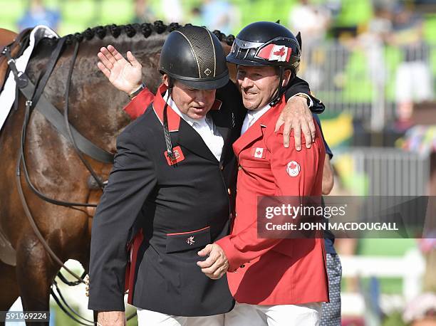 Canada's Eric Lamaze and Britain's Nick Skelton greet each other after the final round of the individual equestrian show jumping event at the Olympic...