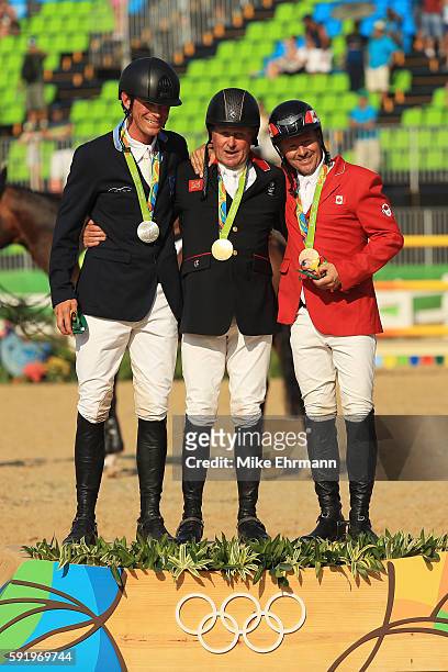 Silver medalist Peder Fredricson of Sweden riding All In, gold medalist Nick Skelton of Great Britain riding Big Star, and bronze medalist Eric...