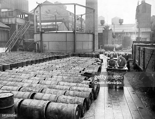 Glimpse of the vast Gaskell-Marsh works at Widnes. The men are conveying loads of sodium formate which goes into the making of Oxalic acid. Circa...