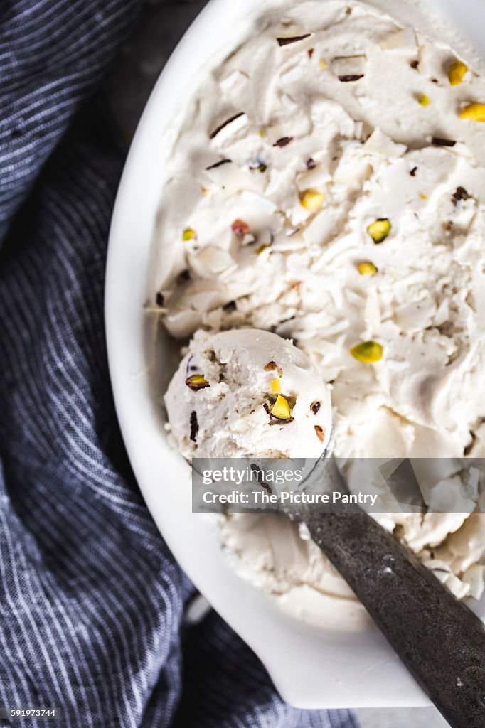 A scoop of ice cream inside an oval bowl
