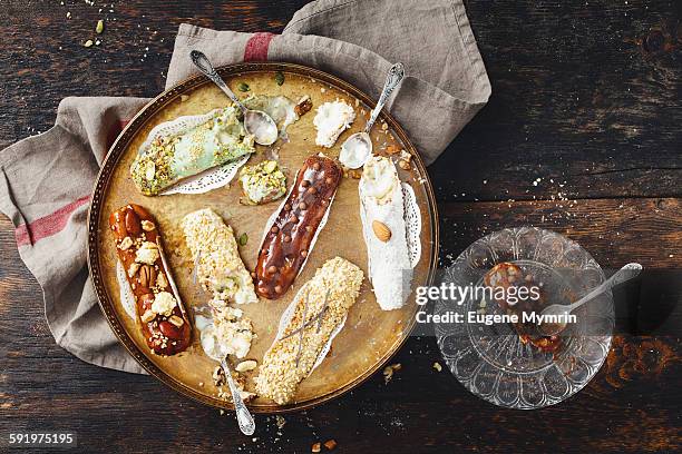 eclairs with different topping - eclair stock pictures, royalty-free photos & images