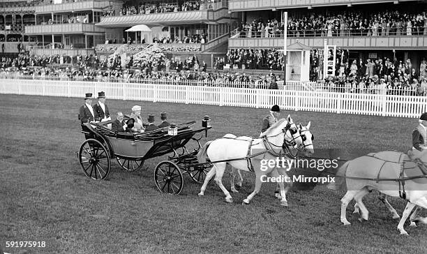 King George V and Queen Mary arrive at Ascot in horse drawn carriage with white horses, June 1931