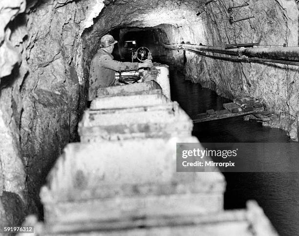 Lead Mine, Rhydymwyn, near Mold, Flintshire, Wales, 5th March 1938. Battery powered locomotive train, operating under flood conditions.