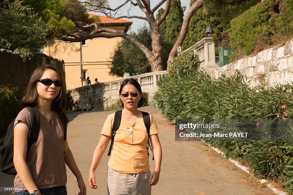 Two Asian women walking in the street