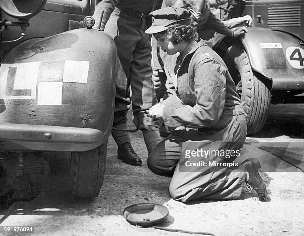 Princess Elizabeth learning basic car maintenance as a Second Subaltern in the A.T.S 12th April 1945.