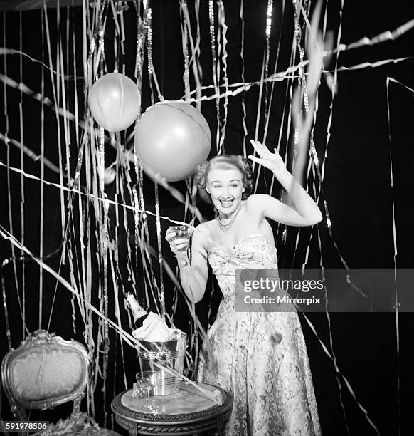 Susan celebrates the New Year with champagne and balloons January 1950. December 1949 O22050-001