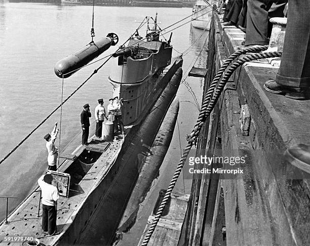 These sailors are being trained in Torpedo and Submarine work to become future crew of vessel, they are taking a torpedo from a crane to be handed...
