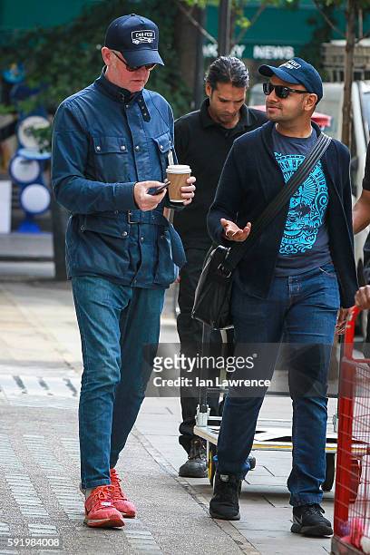 Chris Evans seen making phone calls as he leaves BBC Radio Two studios with his PA on August 18, 2016 in London, England.