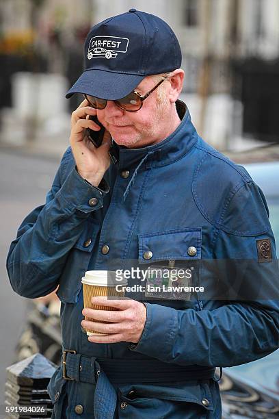 Chris Evans seen on the phone as he leaves BBC Radio Two studios on August 18, 2016 in London, England.