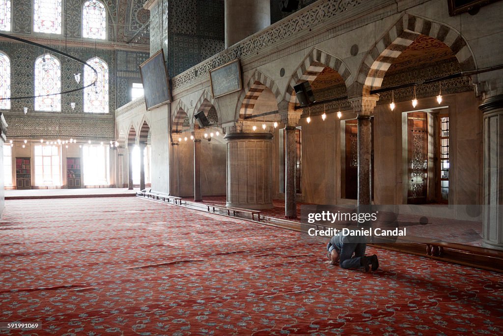 Old man praying in the Sultan Ahmed mosque