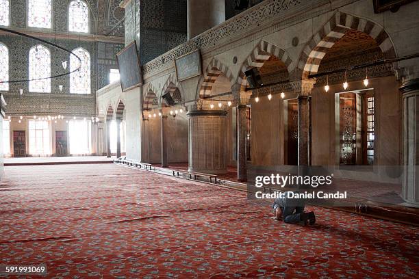 old man praying in the sultan ahmed mosque - old saudi man stock pictures, royalty-free photos & images