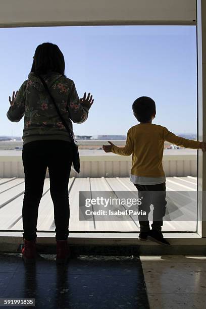 girl and boy looking out window - bruselas bildbanksfoton och bilder