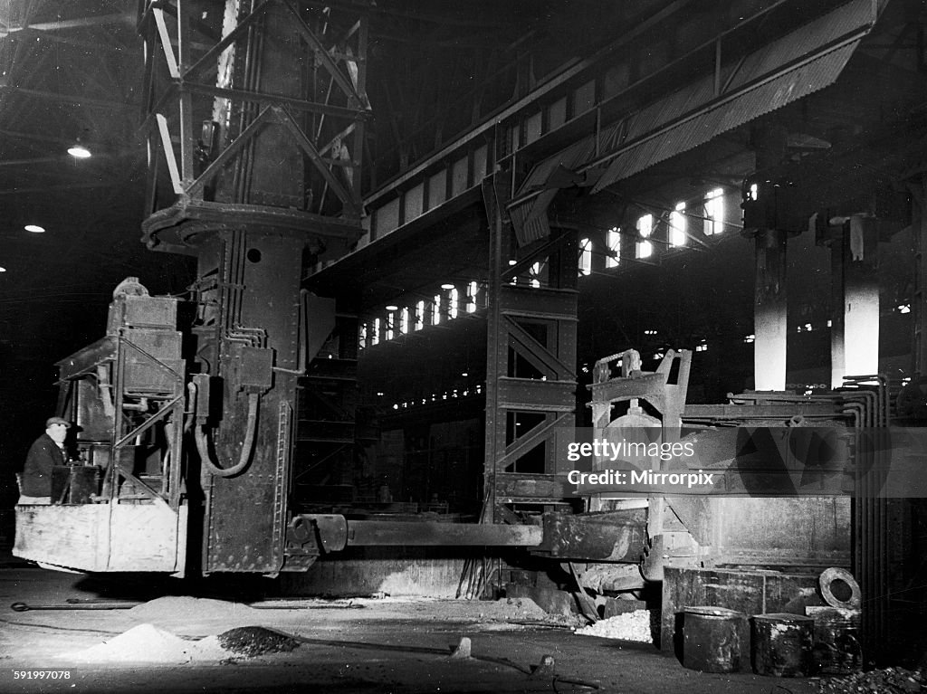 A mechanical charging machine feeding a 30 ton electric arc furnace at the English Steel Corporation Works (Vickers) in