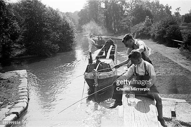 Young boys fishing on a canal near Watford, Hertfordshire. Circa 1945.