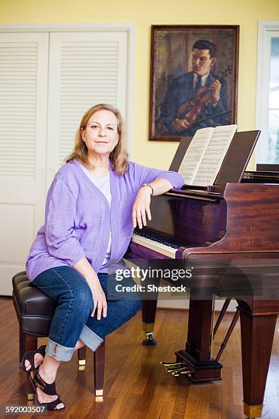 caucasian musician sitting at piano - pianist front fotografías e imágenes de stock