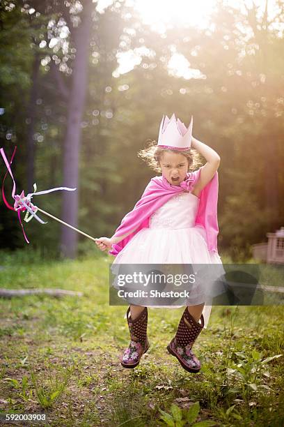 girl playing princess in backyard - furious child stock pictures, royalty-free photos & images