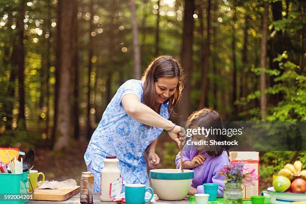 caucasian mother and daughter cooking in forest - long table stock pictures, royalty-free photos & images