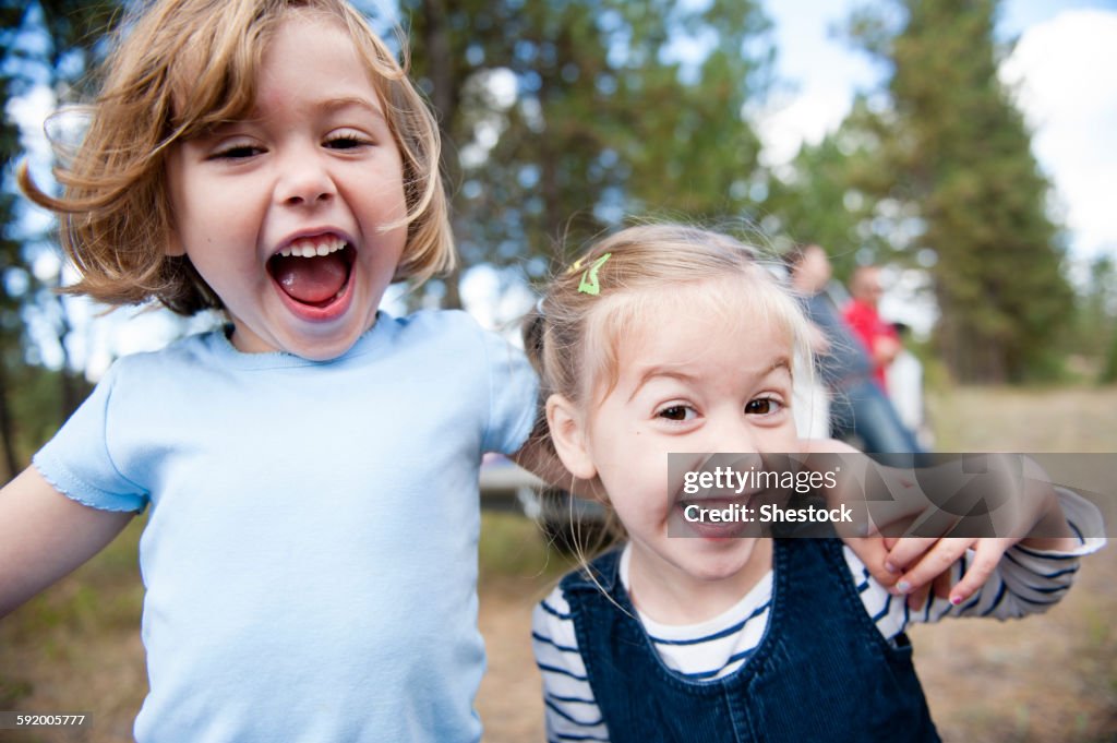 Close up of Caucasian sisters hugging outdoors