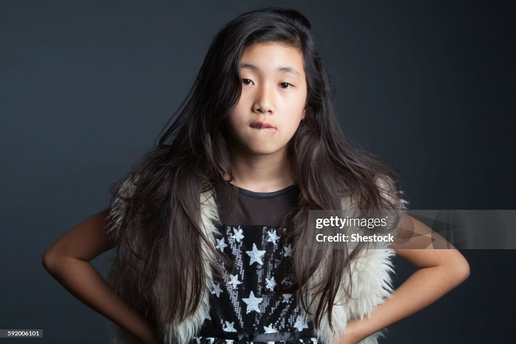 Asian girl standing with hands on hips