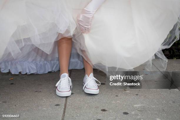 teenage girl wearing sneakers under quinceanera dress - married imagens e fotografias de stock
