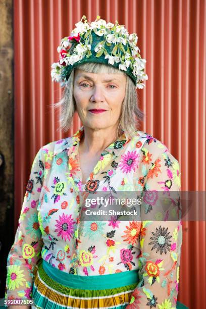 stylish older caucasian woman wearing floral cap - spinner stock-fotos und bilder