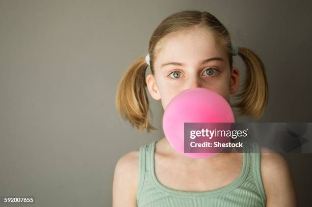 caucasian girl blowing gum bubble - bubble gum kid stock pictures, royalty-free photos & images